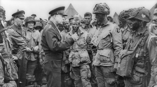 General Dwight D. Eisenhower, Supreme Commander of the Allied Expeditionary Forces in Europe (SHAEF), speaks with First lieutenant Wallace C. Strobel and men of Company E, 2nd Battalion, 502nd Parachute Infantry Regiment on June 5, 1944. Strobel’s battalion was the first to drop into Normandy. Strobel survived Normandy and the war. (US Army)